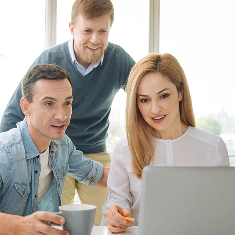 A group of employees eagerly stare at the News section of our website.